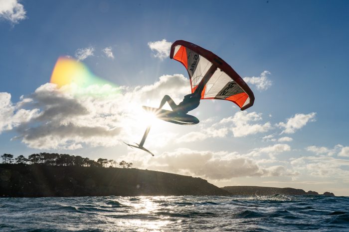 A rider getting airtime while wing foiling using AFS equipment.