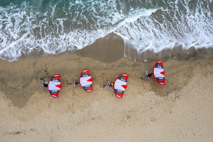 An overhead view of a group preparing to wing foil.