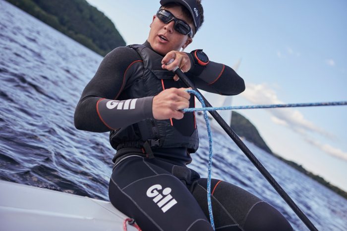 A sailor holding on to a control line.